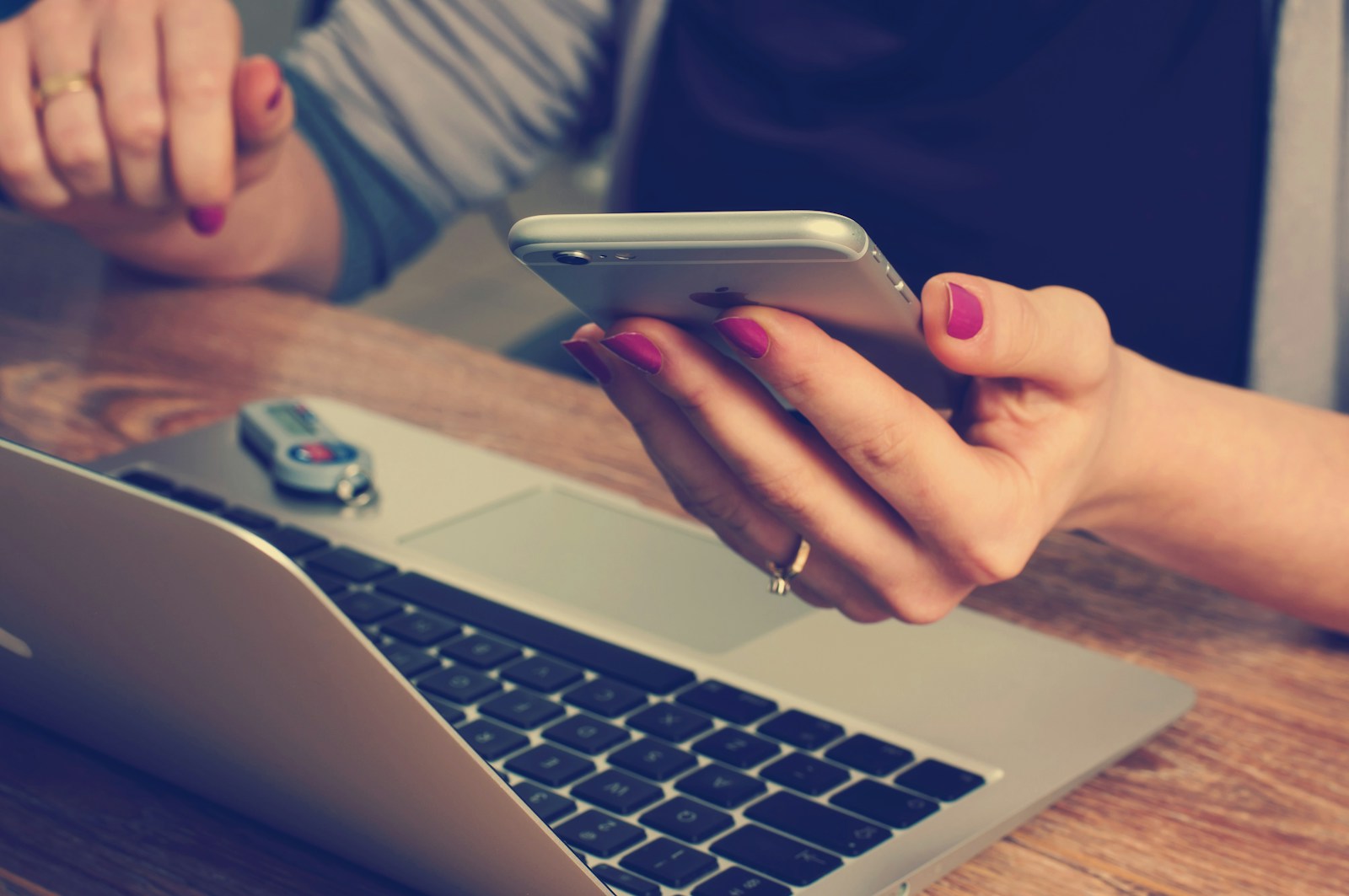 woman holding silver iPhone 6, cybersecurity tools